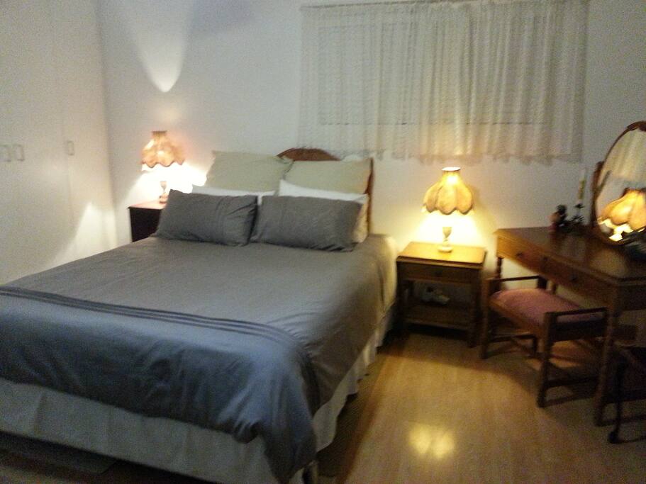 Queen size bed, built in cupboard with shelves and hanging space