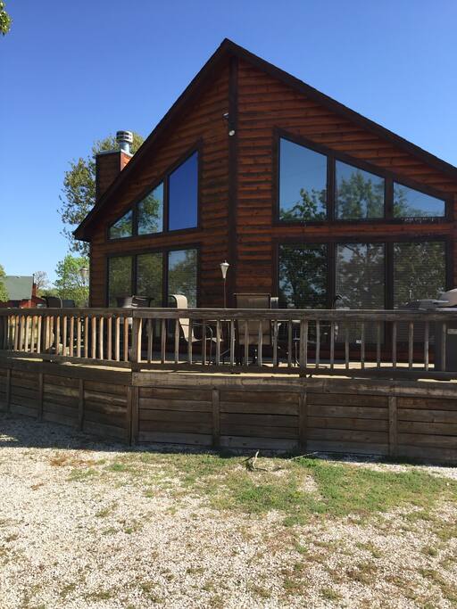 The deck has 2 tables and a grill.