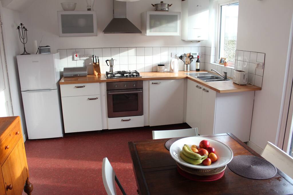 Kitchen / dining room with open fire.