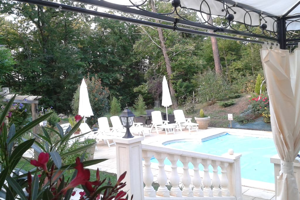 view of the pool area from outdoor dining