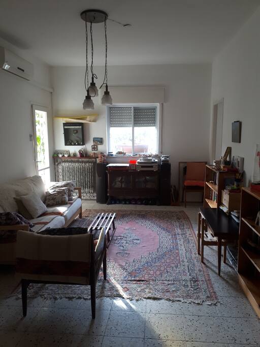 Living room with sofa bed that can serve as a double bed. underneath the sofa two mattresses are hiding for extra people or extra comfort.