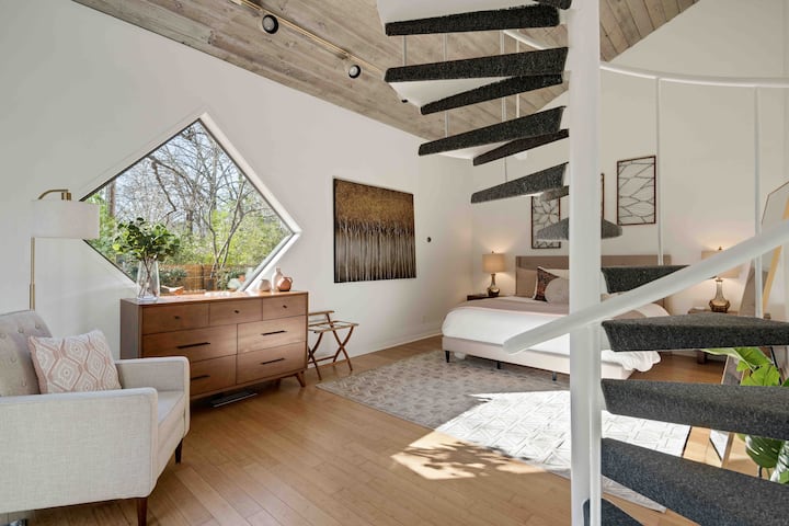 Master suite with a Cal King bed, spiral staircase that leads to a private office.