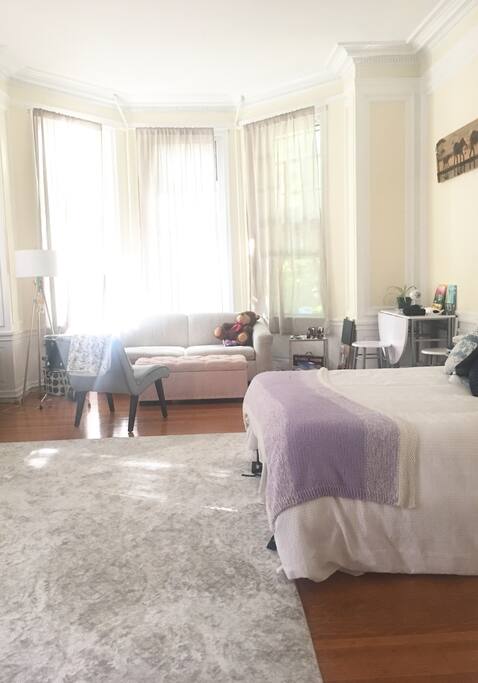 Huge room with high ceilings and 5 windows. Full size bed, pull out couch, high top table with 2 seats for working and/or eating. There's a piano to the left that you can't see in this picture... feel free to play it!