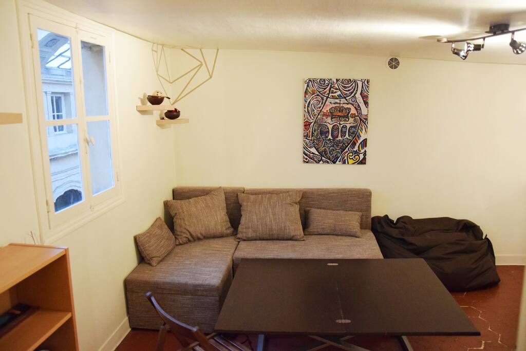This is the living room. With a large sofa and a big table.