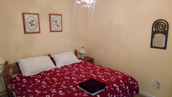 Upstairs, the en-suite master bedroom looks out onto the lawn. Bathroom 1 is a private en-suite to this double room.