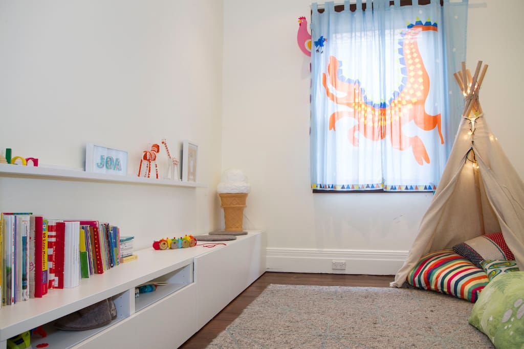 Kids room with teepee, books and a king single mattress.