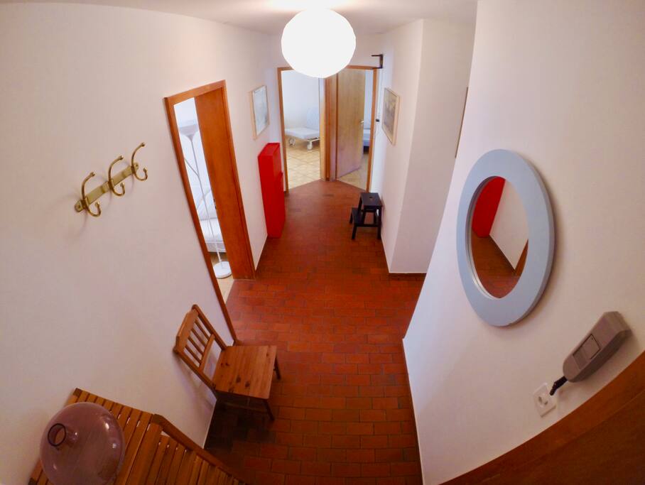 Corridor connecting the rooms with kitchen and bathroom.
