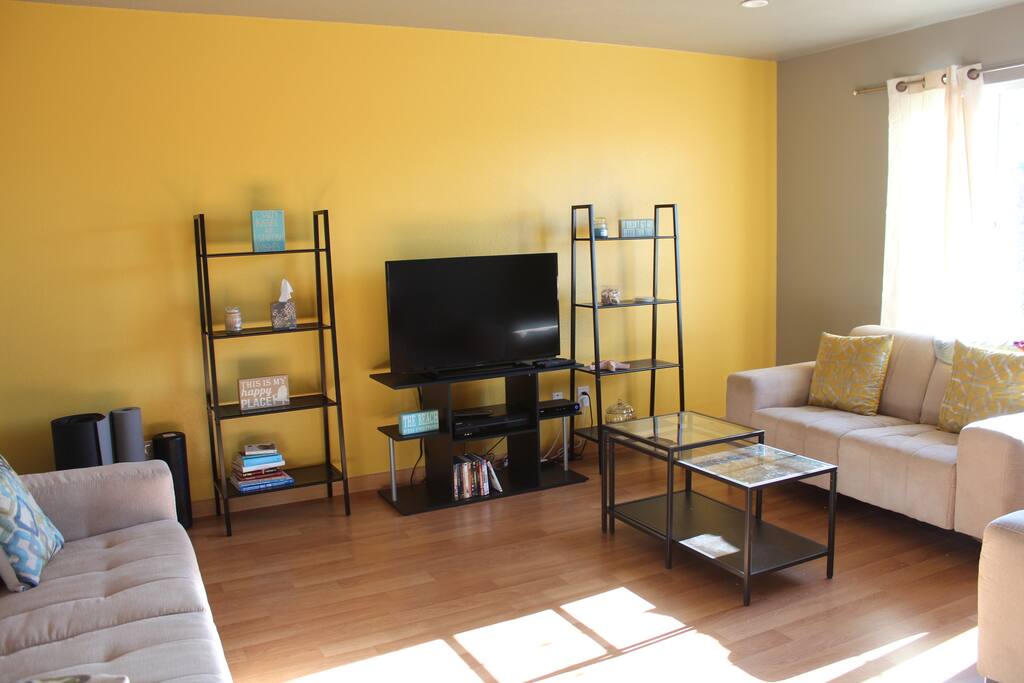 The living room with a tv and views out front.