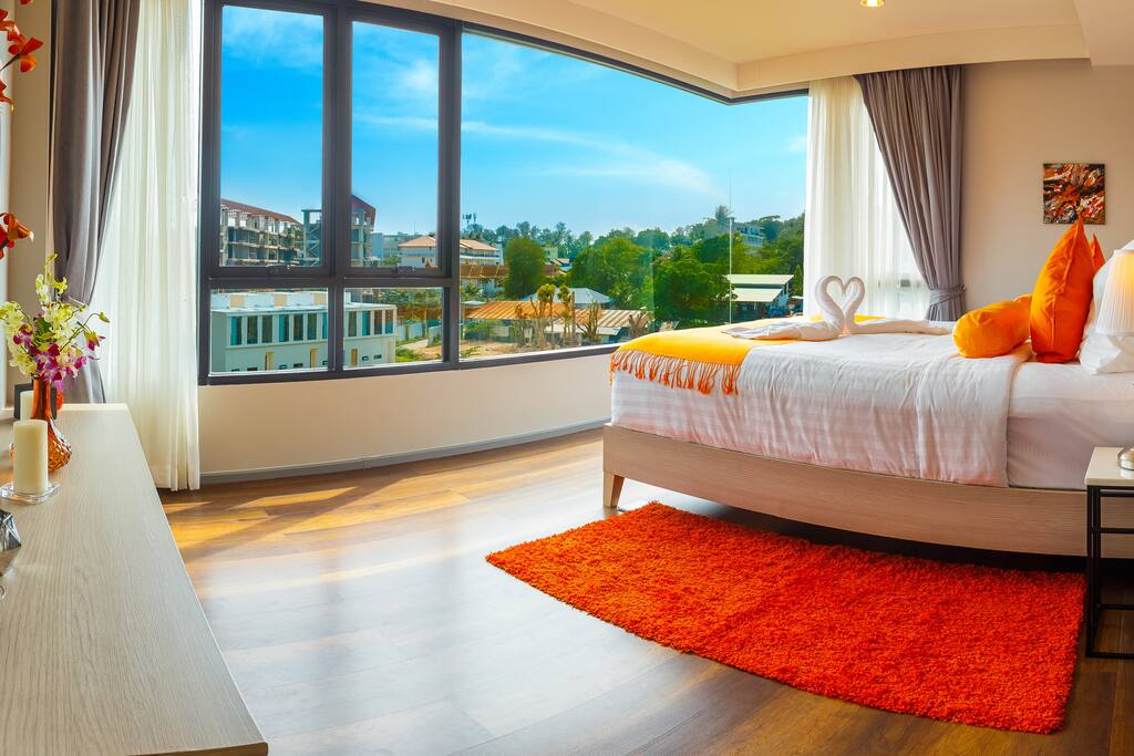 A hotel room with a large window