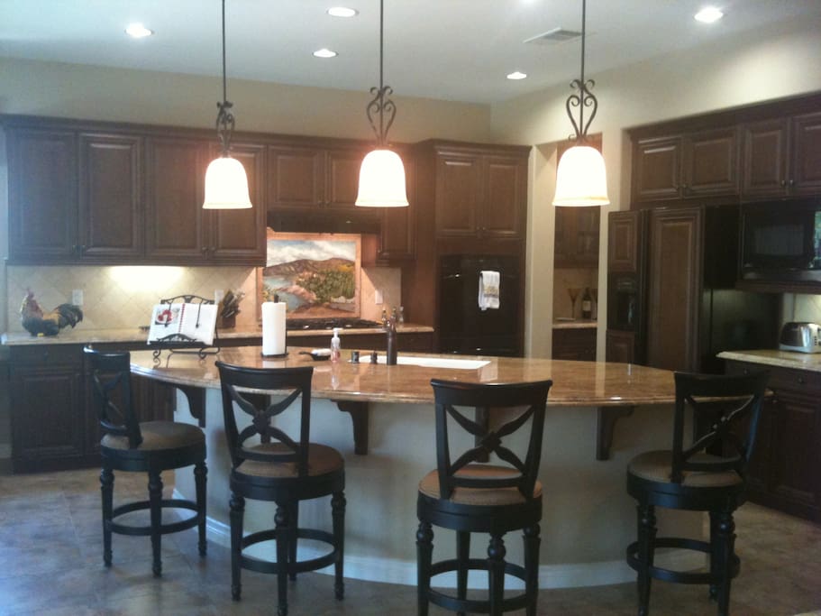 Huge kitchen with granite counter top and breakfast bar perfect for entertaining