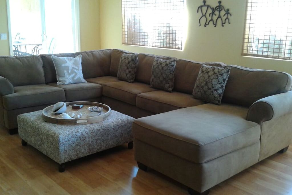 Great room seating with glass door entrance to outdoor lanai dining