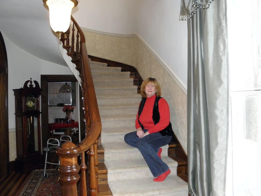 Curved original stairs and intricate hardwood flooring leading upstairs to all the rooms.