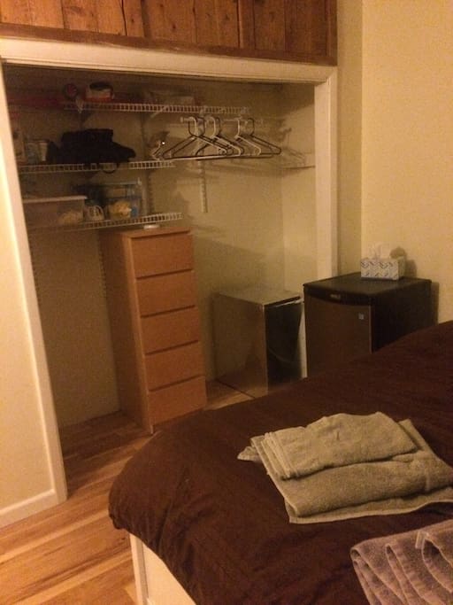 Full size closet with access to a refrigerator
