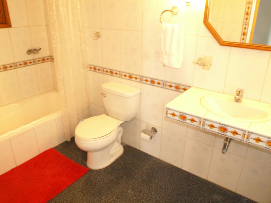 Beautiful and clean bathroom with tub, hot water both in the tub/shower and sinks.