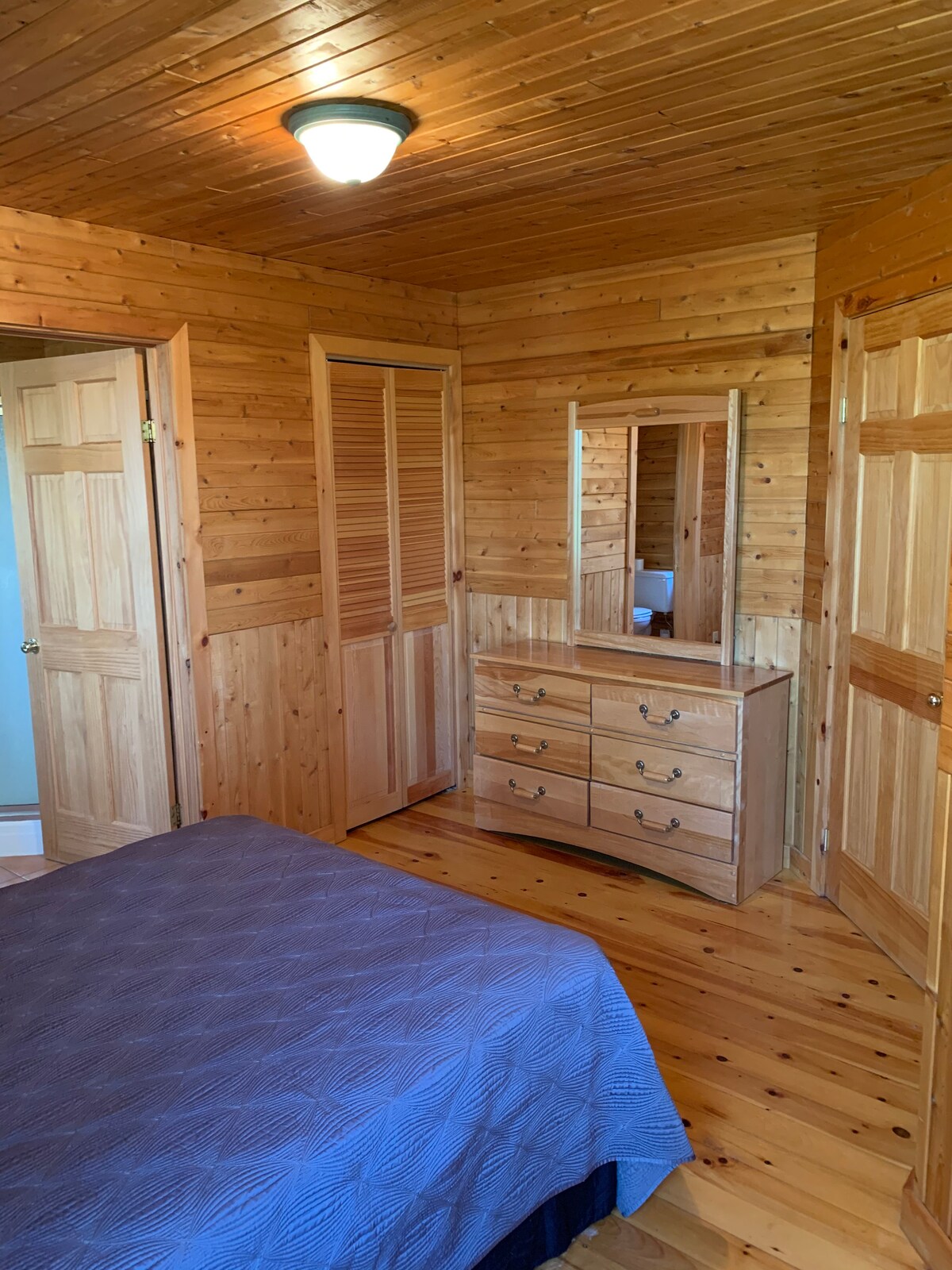 Spálňa pri rieke č.1 - všetok nábytok z masívneho dreva. Tu môžete vidieť spálňu, kúpeľňu a vchod do šatníka. Dvere spálne sa otvárajú do priestoru obývacej izby. 