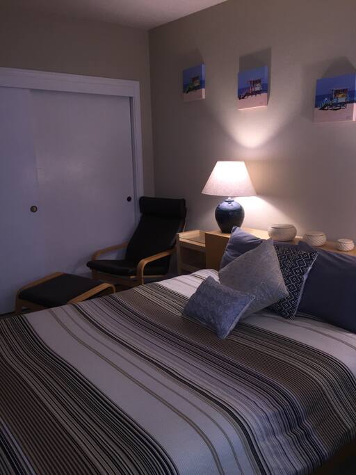 Wall to wall closet, chair and foot stool to relax in
