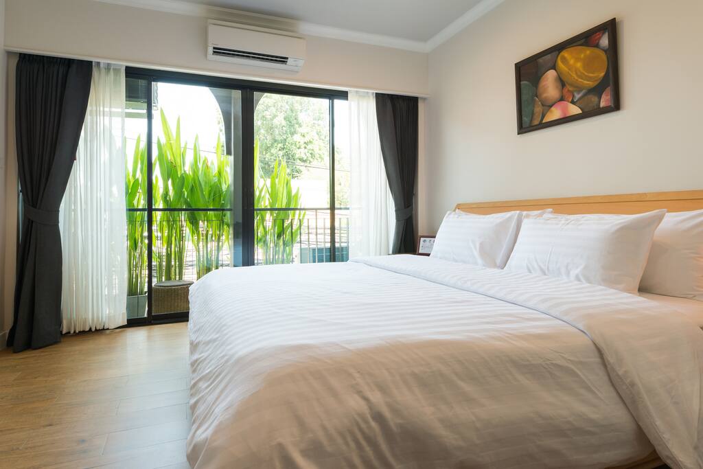 Comfortable king size bed with balcony.