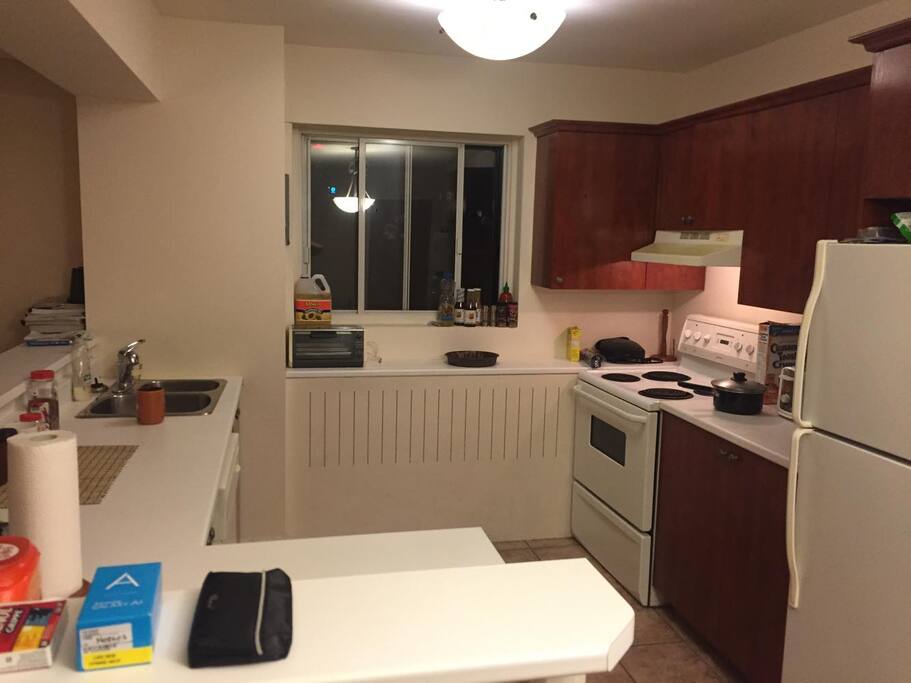 Kitchen attached to lounge and has bartop