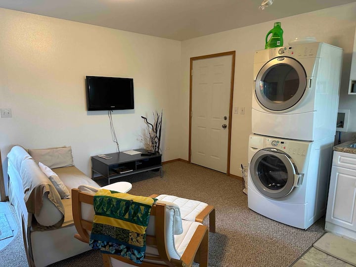 Living space, couch for extra sleeping space, full size washer and dryer,  door to private deck