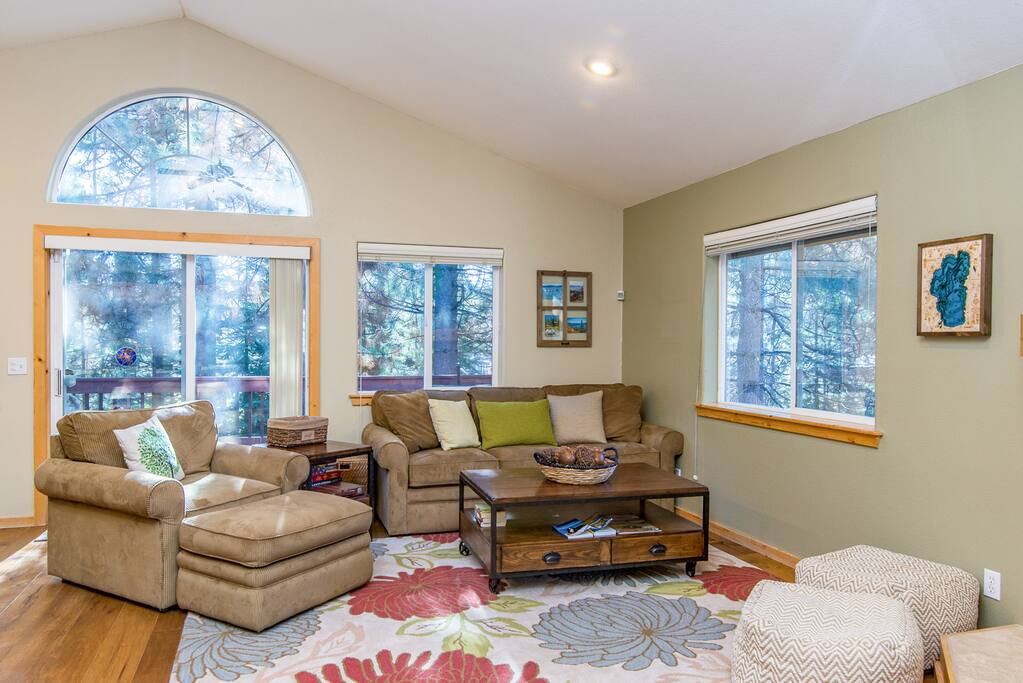 Outfitted with a plush armchair and sofa, the living room offers an inviting social space in which to unwind.