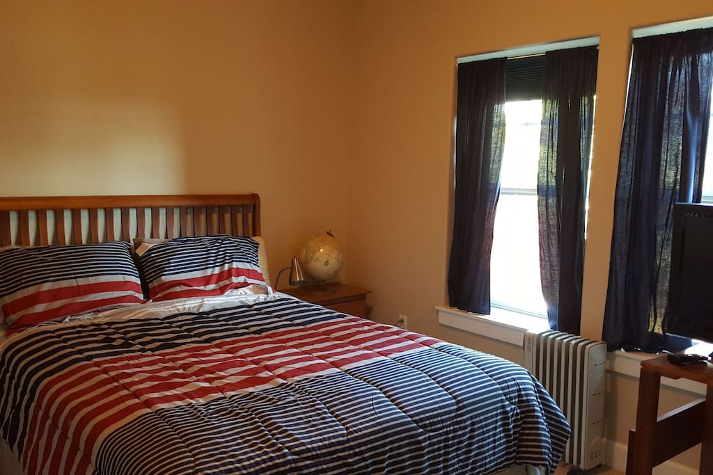 Bedroom offers queen bed, dresser, and closet space.
