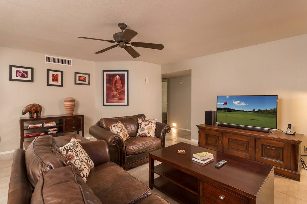 The living room has a large 50” 4K UHD television and sound bar with leather furniture and a nice bay window. There is Wi-Fi and a blu-ray player