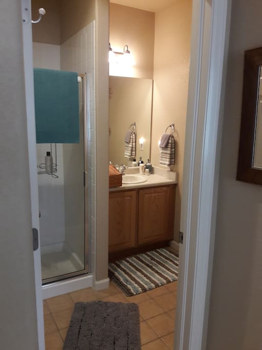 Bath with shower, towels, shampoo, soap, etc