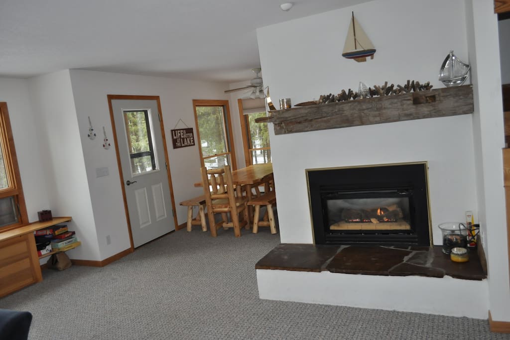 Fireplace to the right and cedar dining table to the left.