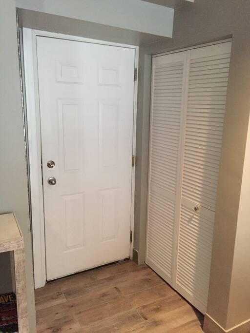 Just inside, coat closet by entry