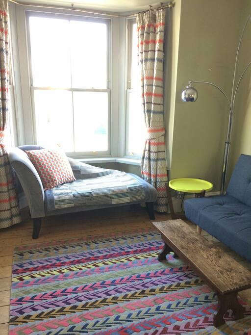 The split level flat is colourfully furnished with contemporary textiles