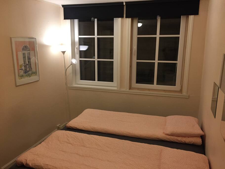 View of room showing double bed (can be arranged as two single beds) and blackout curtains making sleeping a pleasure in light summer nights. ligh