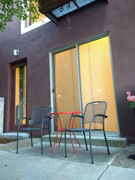 Red table and outdoor set in courtyard to help find the door.