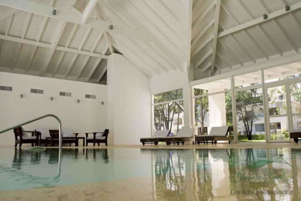 Indoor pool with steam room and sauna amenities.