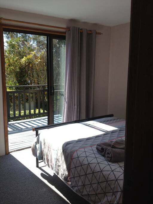 Bedroom 1 showing sliding door to outside balcony.
