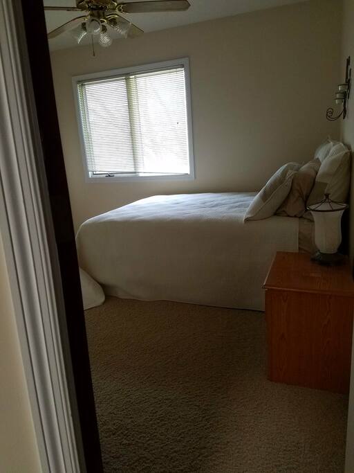 Queen size bed in bedroom 2.
