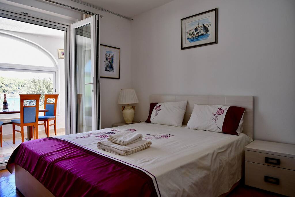 Bright clean and comfortable bedroom with ample storage and magnificent view of the garden, sea and the islands from your private room.
