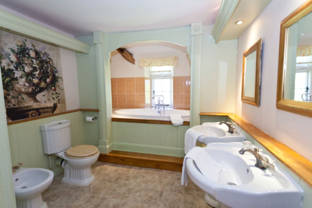 Luxury bathroom with jacuzzi bath, shower & his & hers sinks