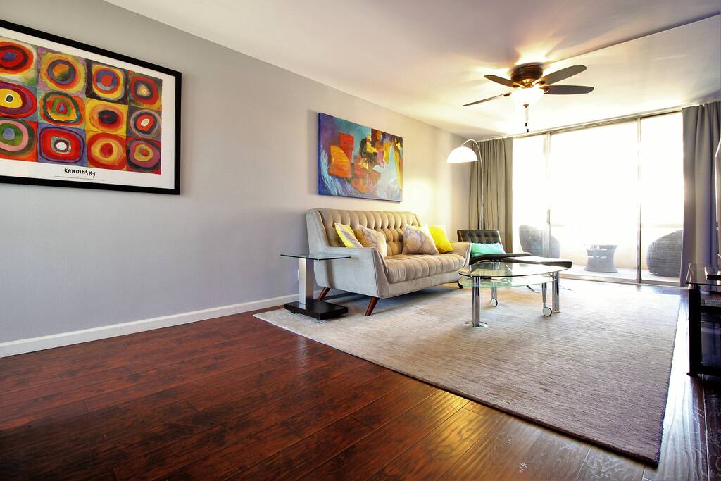Original artwork hangs above the sofa.