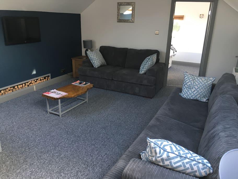 Lounge with Sofa Bed, TV (free view) coffee table and side tables