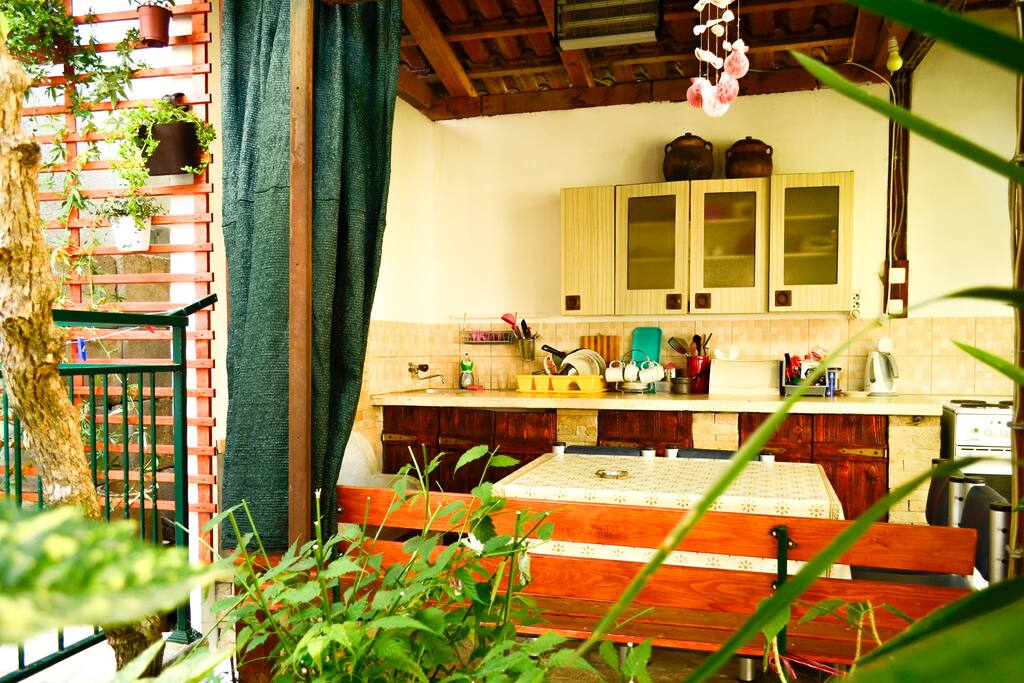 Outdoor kitchen and dining area is roof-covered and located in a part of our garden. It contains barbecue, all necessary kitchenware and cookware for meal preparation, serving and dining.