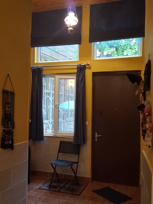 Entry way. Roman shades allow for additional light from outside and privacy when dropped.