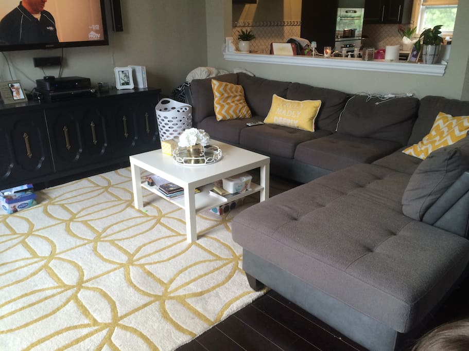 Living room, with a sectional and a 50" TV.