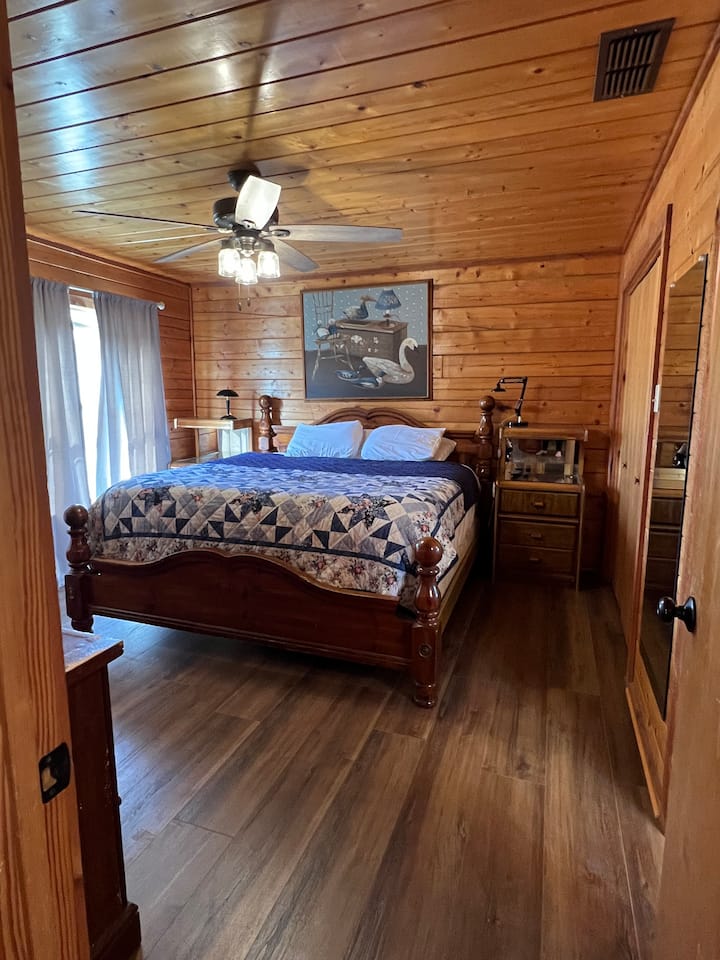 Chumba kikuu cha kulala chenye kitanda cha ukubwa wa king. Mahali pazuri pa kupumzika na kutazama televisheni kidogo.