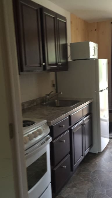 Kitchen in our 1 bedroom cottages with screened in porches.