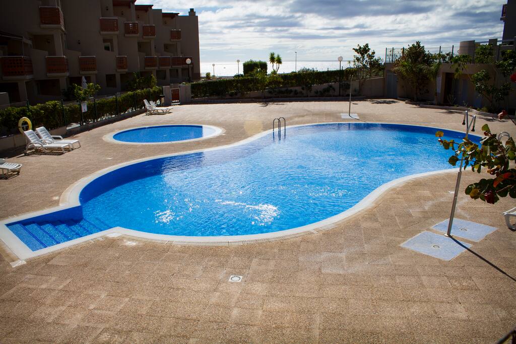 pool with communal sunbeds