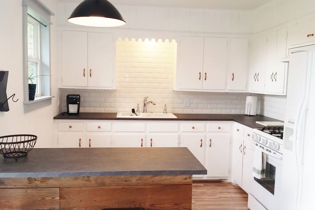 The adorable vintage kitchen has everything you need and enough space to cook up a big meal...just to plate your take out...or to microwave popcorn for movie night!