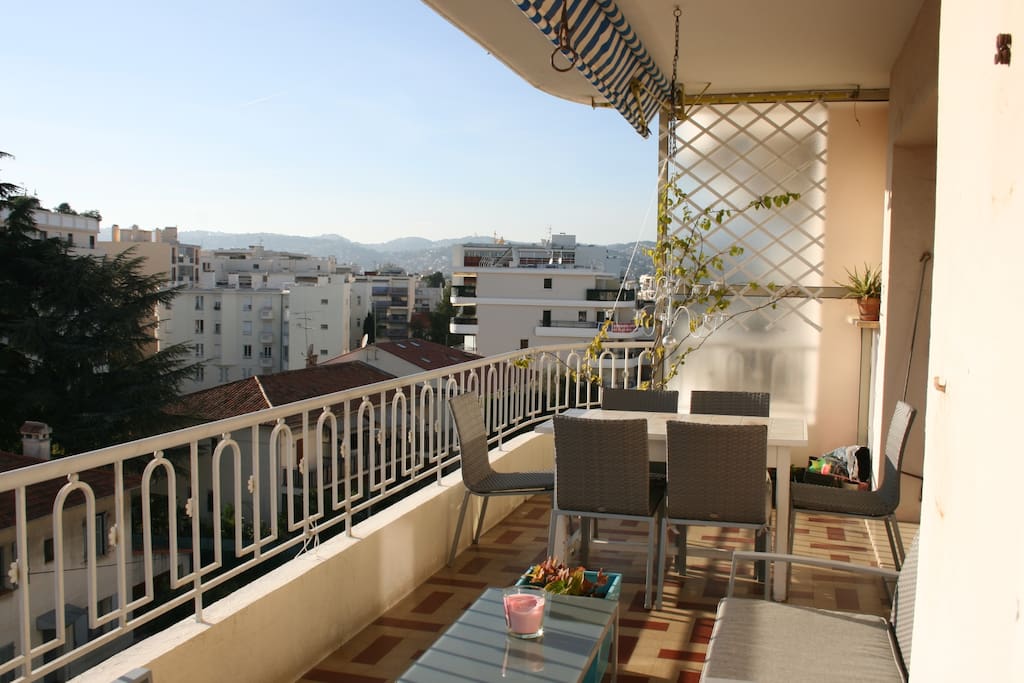 Large terrace with dining table, sofa and sun beds