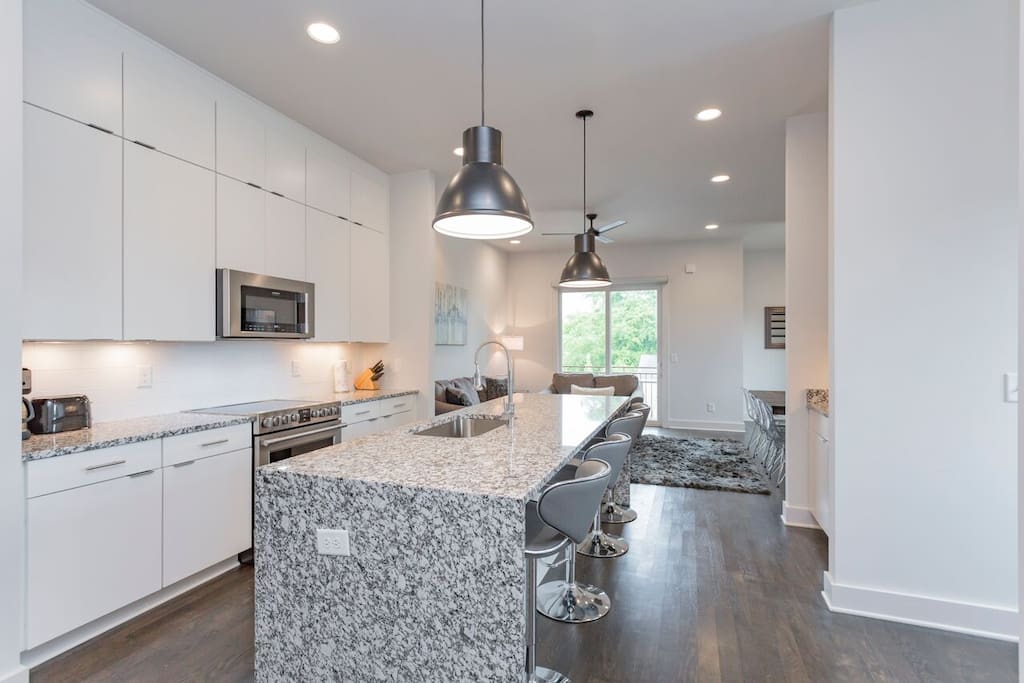 Our second floor welcomes you with our spacious kitchen, living room, wet bar, and king suite