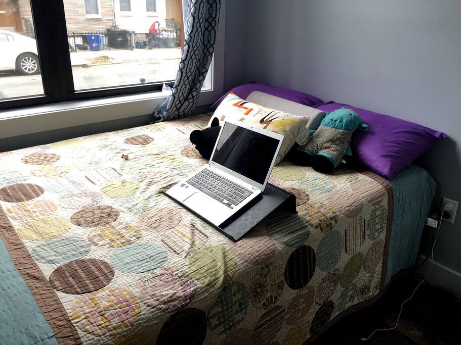 Comfy full sized bed adjacent the windows