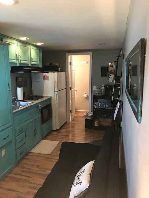 Two burner stove, microwave, full fridge, pots & pans, dishes